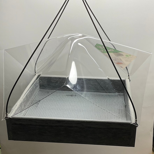 Hanging transparent canopy over a gray square feeder on a white background.