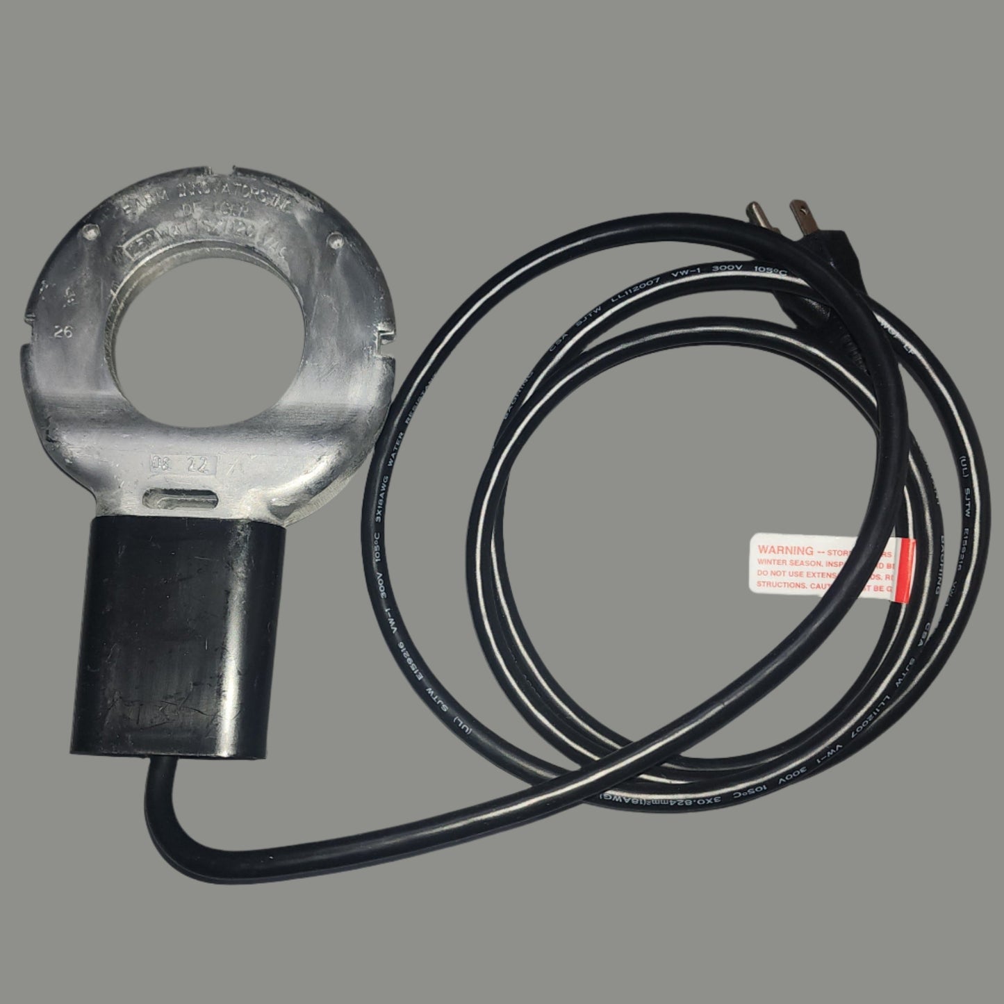 Silver round heater with black handle and cord
