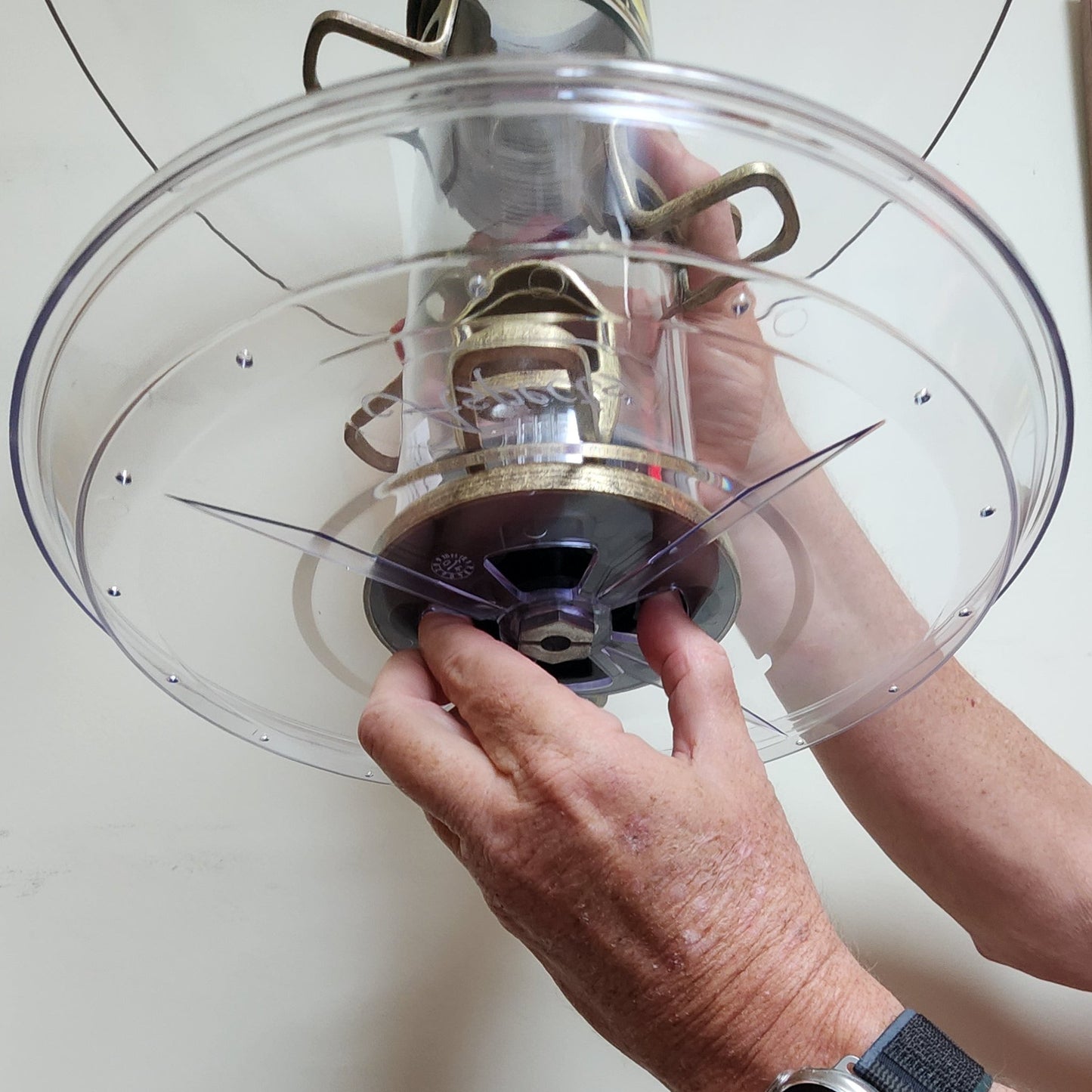 Clear tray being removed from a tube feeder with brass ports