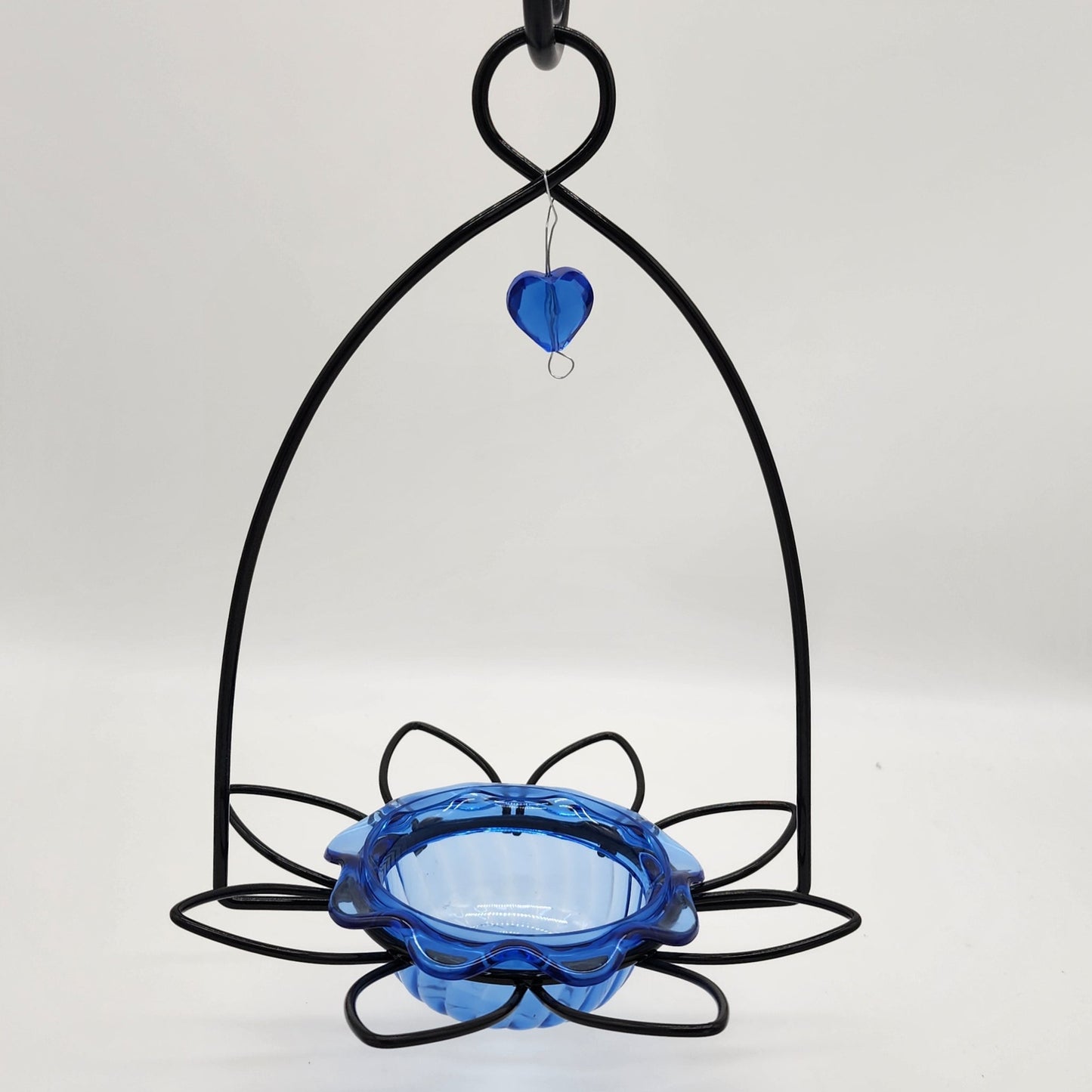 Blue bowl and black flower shaped wire feeder