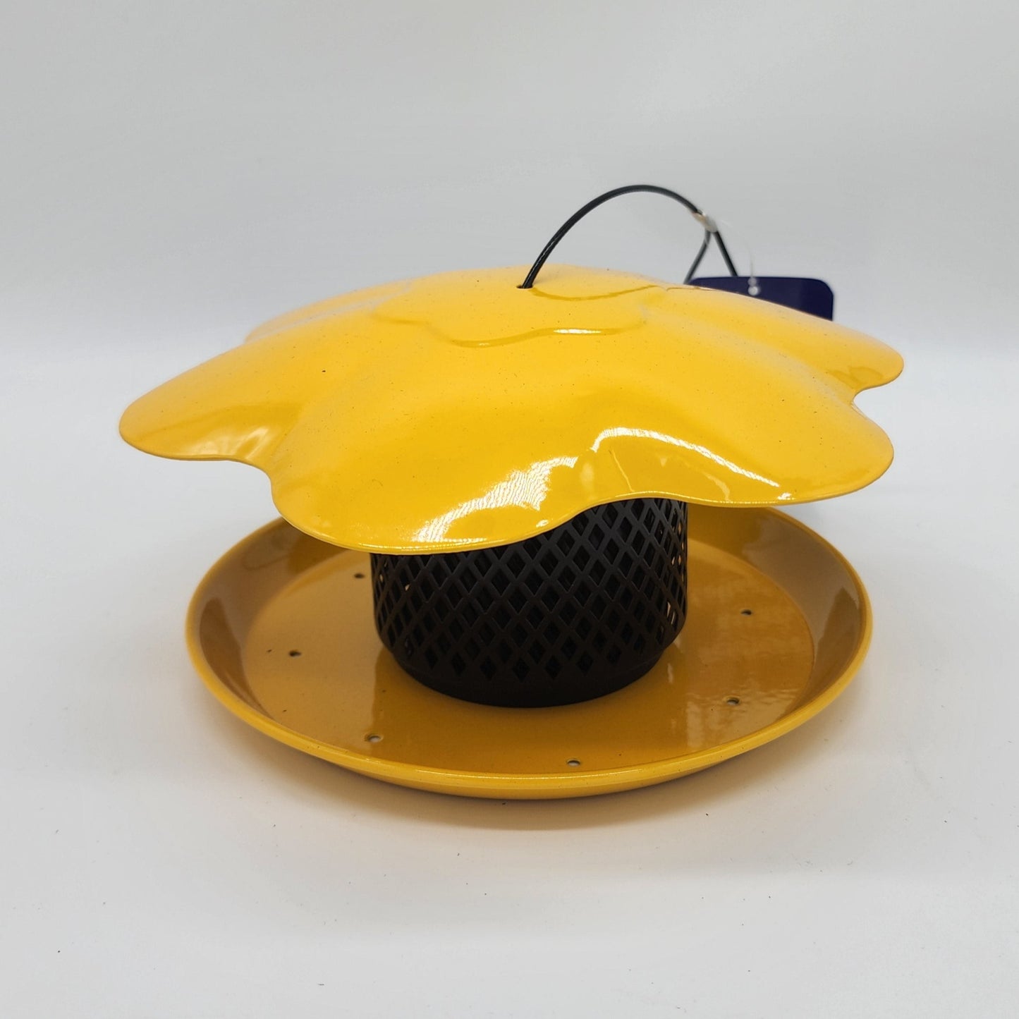 Collapsed black mesh feeder with yellow roof and base with black hanger