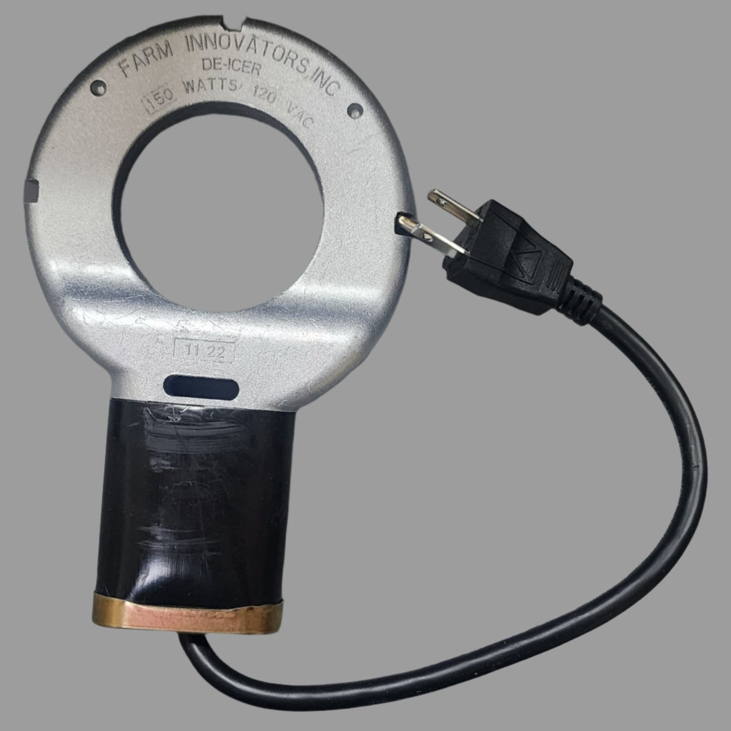 Round silver metal heater with black handle and cord