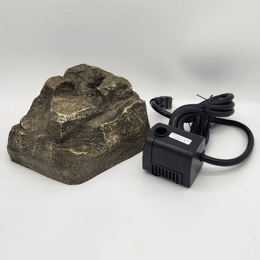 Gray faux granite rock with hole and black pump with cord