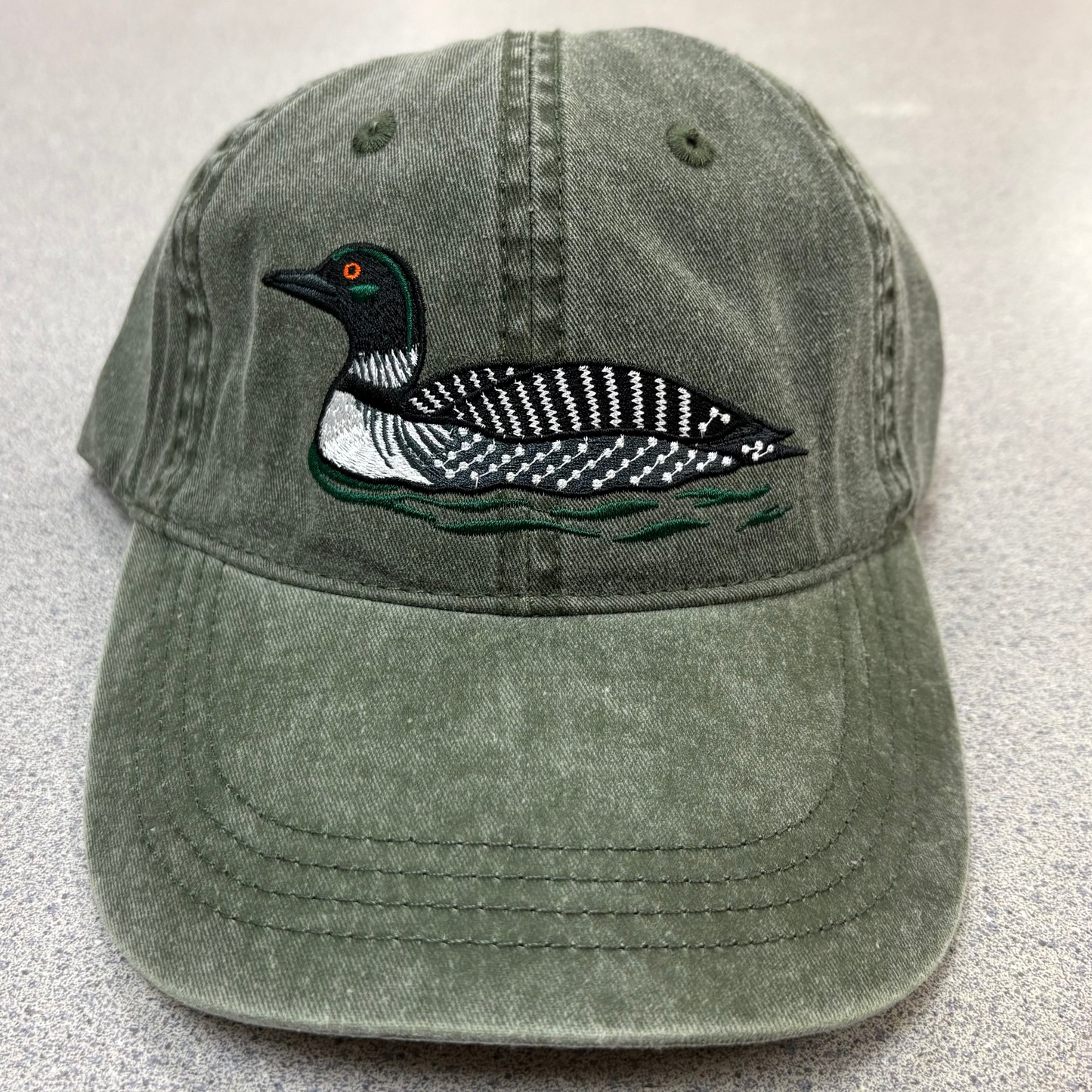 Green ballcap with stiched Common Loon