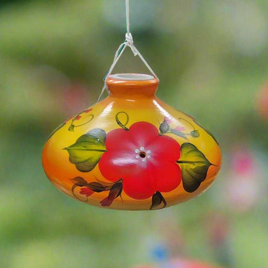 Orange and yellow ceramic feeder with red posy flower and leaves