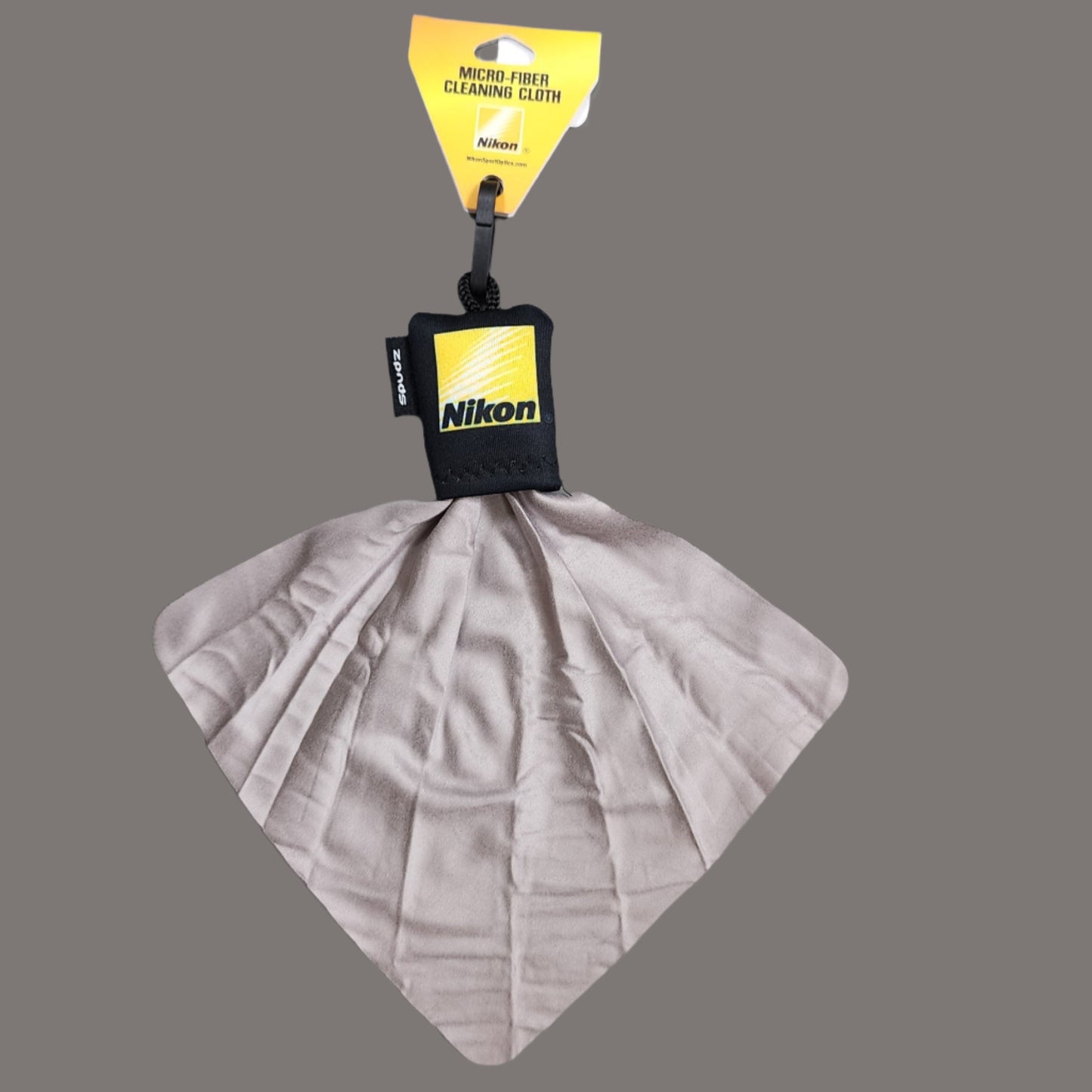 Yellow Nikon logo on black zipper pull with cloth extended