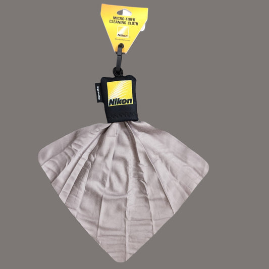 Yellow Nikon logo on black zipper pull with cloth extended