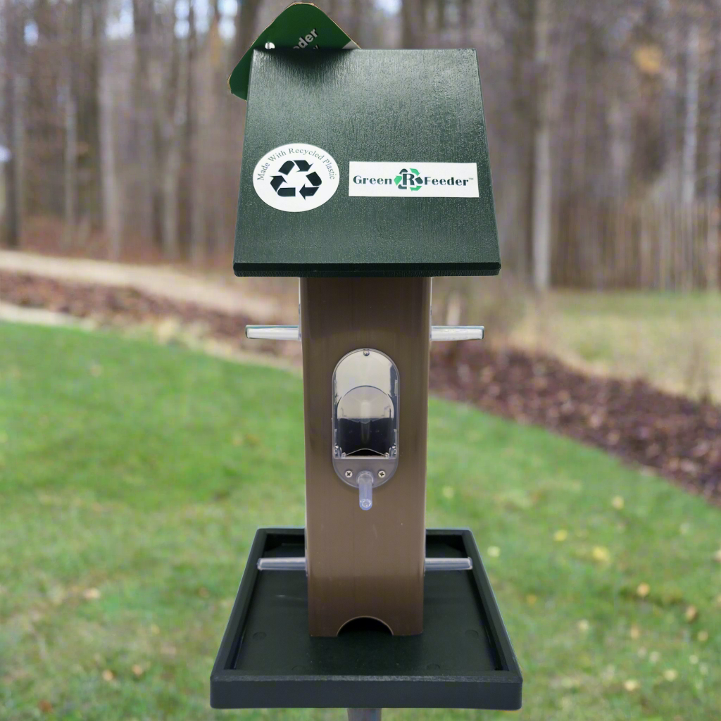 tan bird feeder with green roof and tray