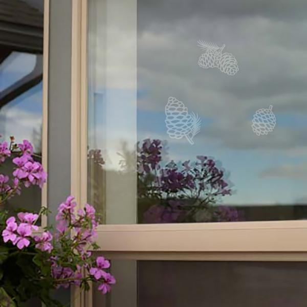 Translucent pine cone stickers on a window