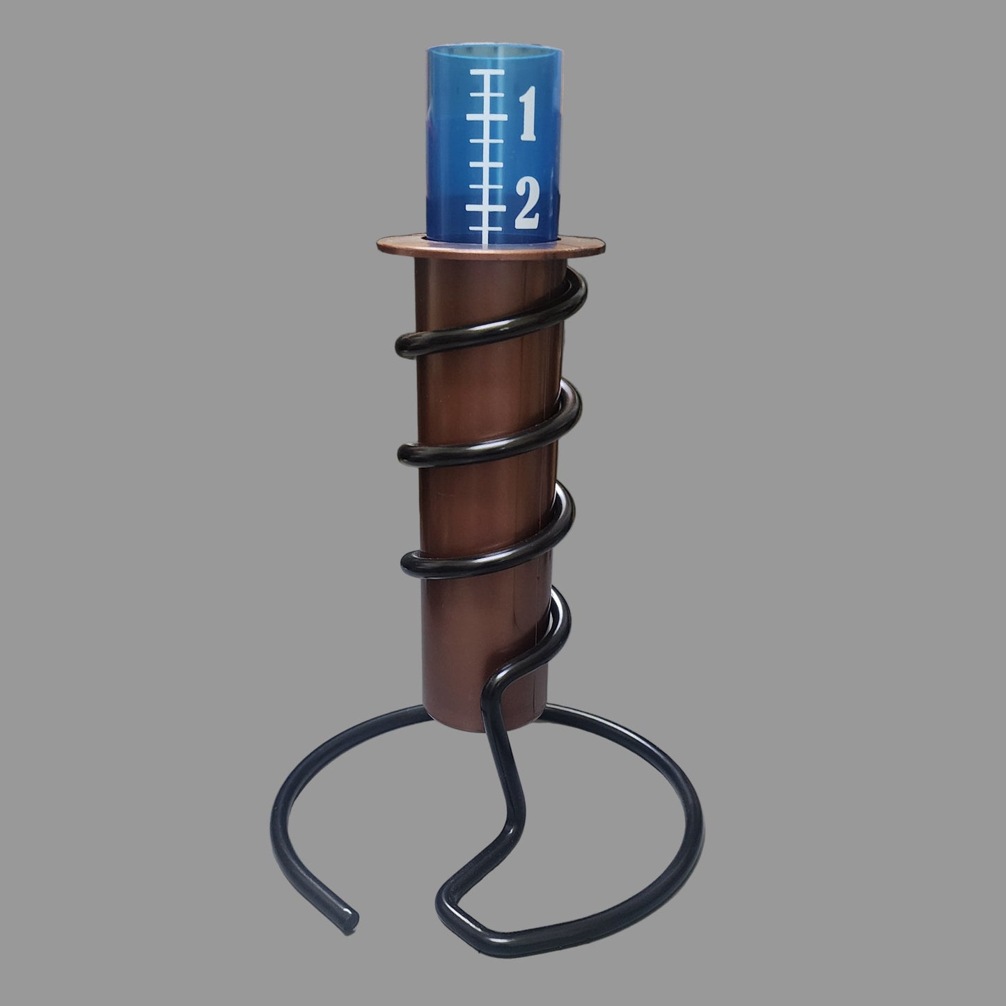 Copper rain gauge tube with blue and white insert and black spiral holder and base