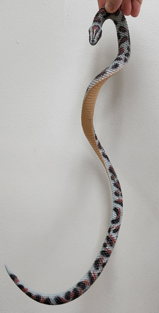 gray rubber snake with red and black spots and tan belly