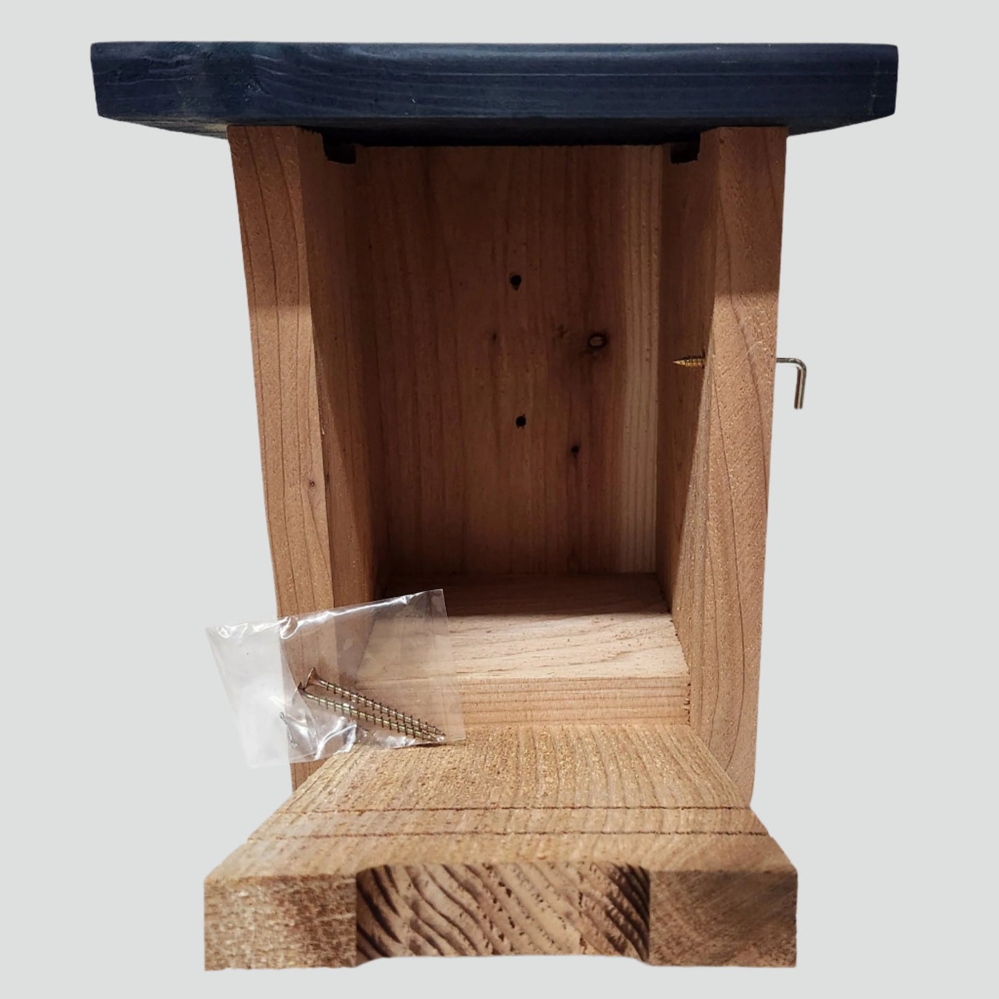 cedar bird house with blue roof and front open