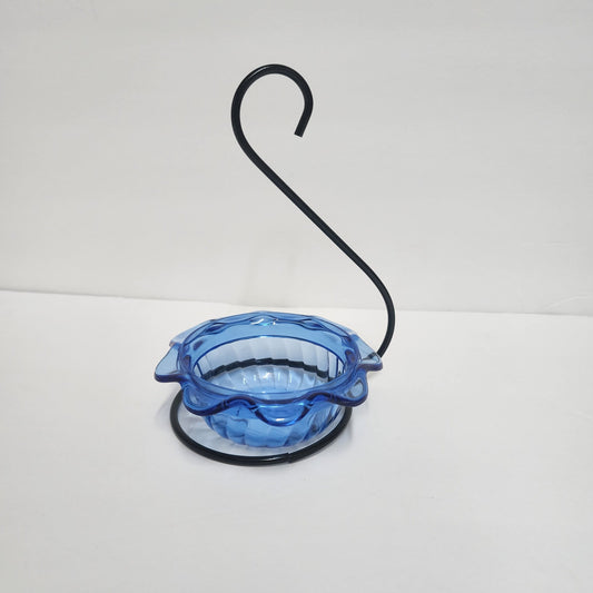blue scalloped bowl with black wire hanger