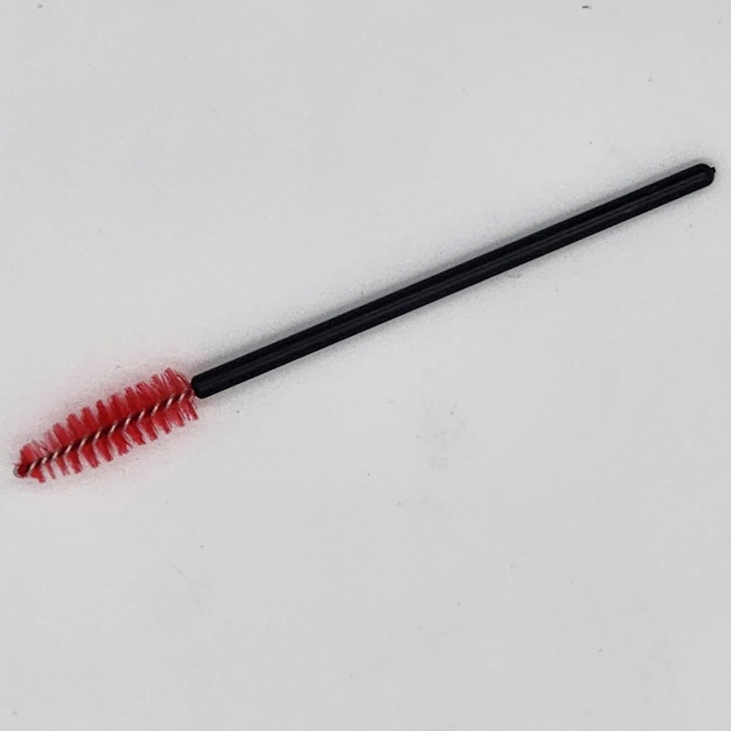 small red brush with black handle