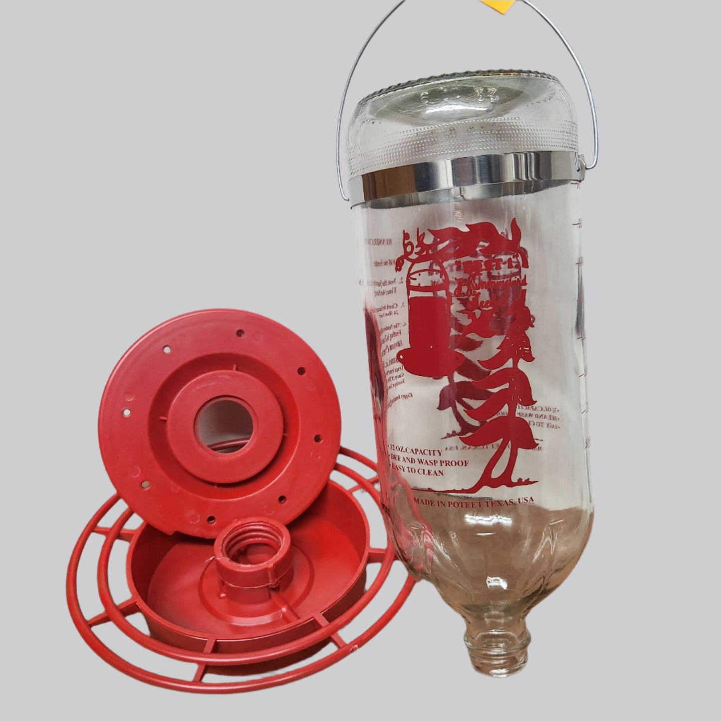 Clear bottle with red image and two piece base disconnected