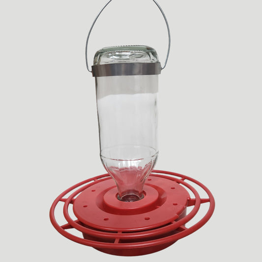 clear bottle with red bas and silver hanger