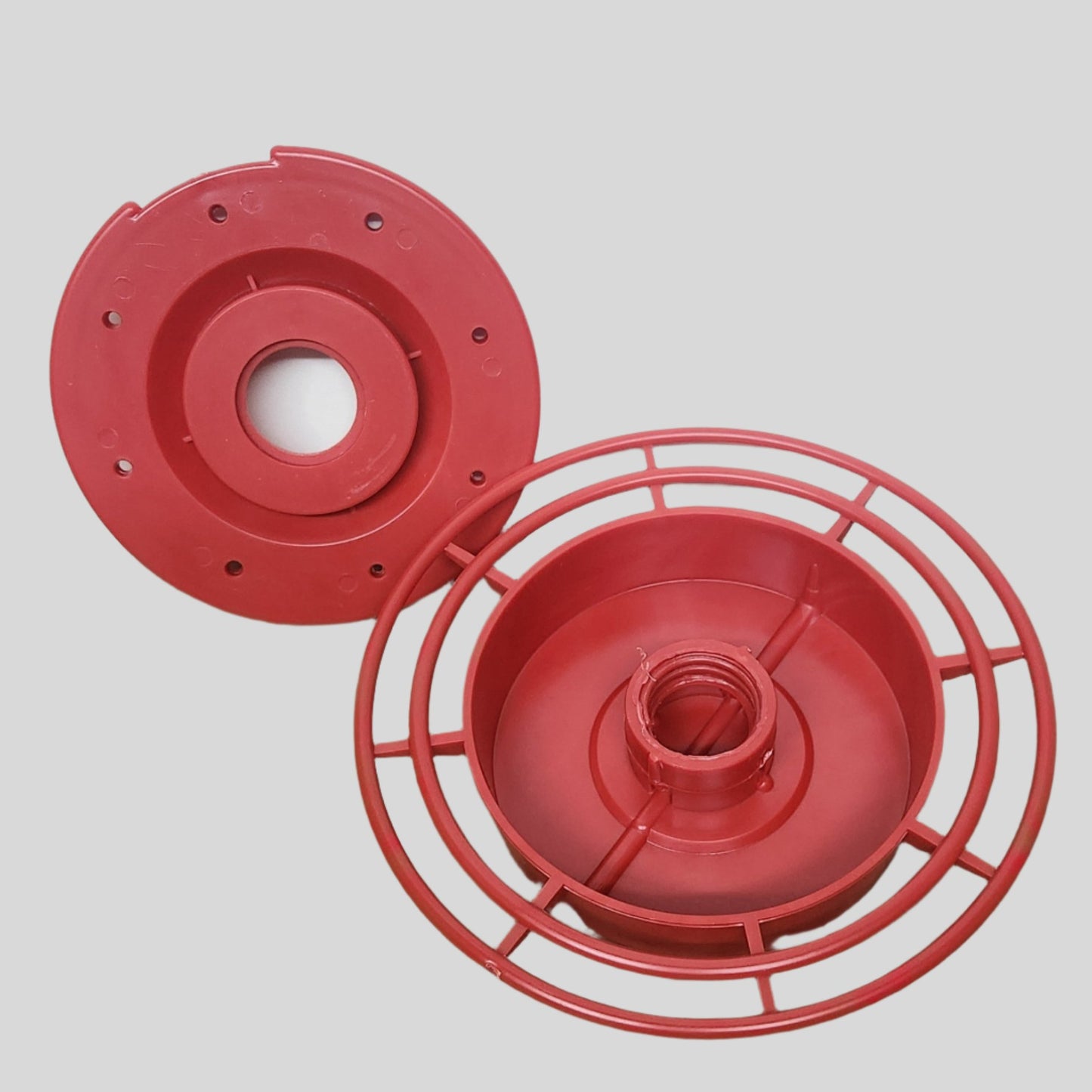 two red plast parts, one with landing perches