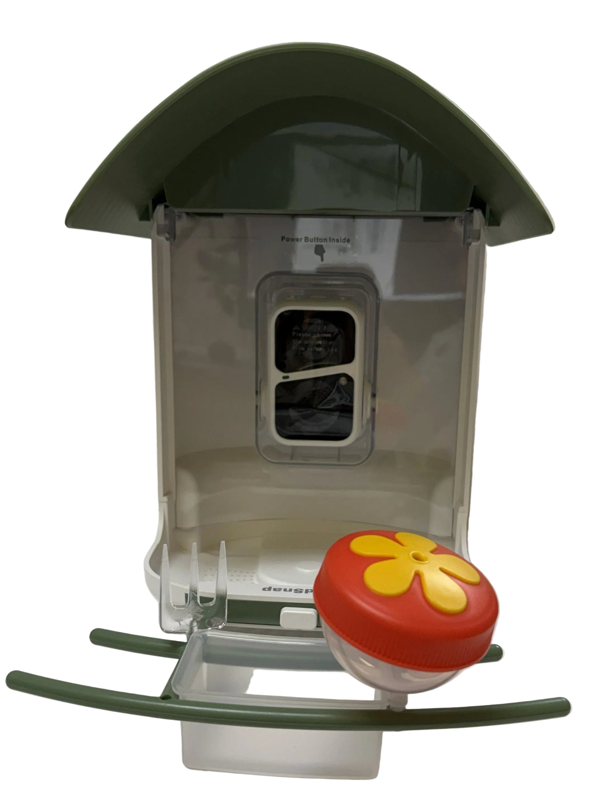 Small transparent birdhouse with a red and yellow flower on a white surface