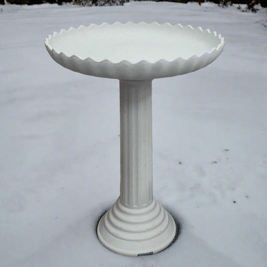 White scalloped bird bath on pedestal