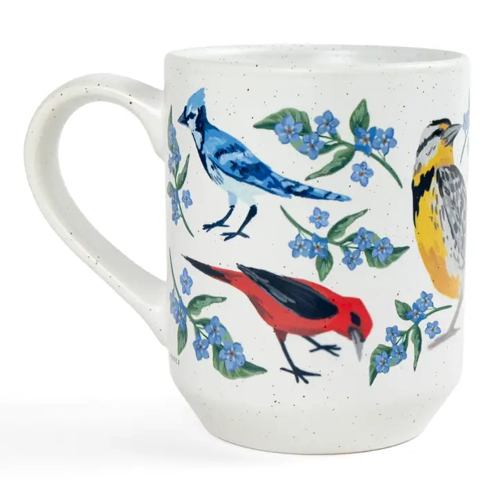 White mug with colorful bird and floral design on a white background