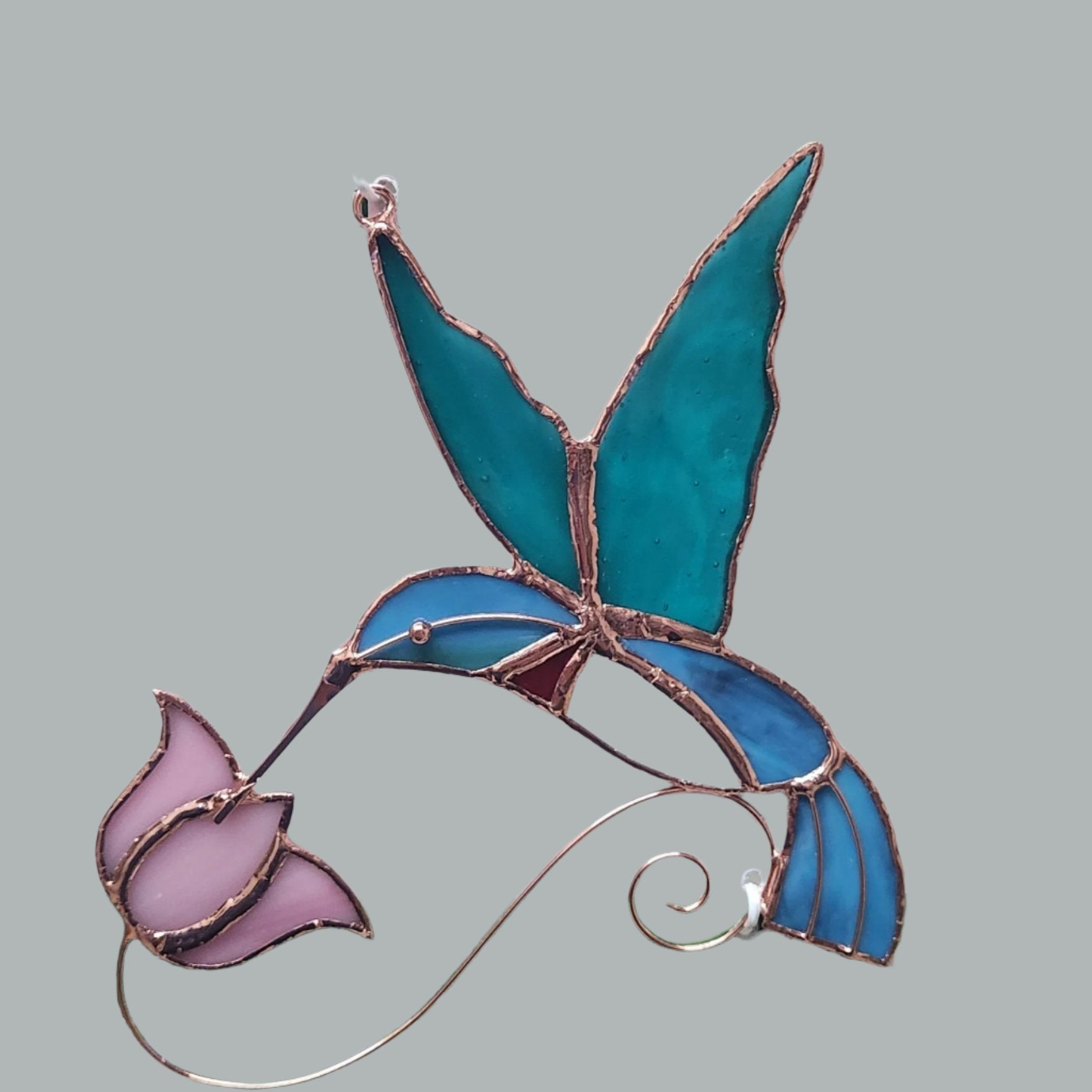 Blue hummingbird and pink flower