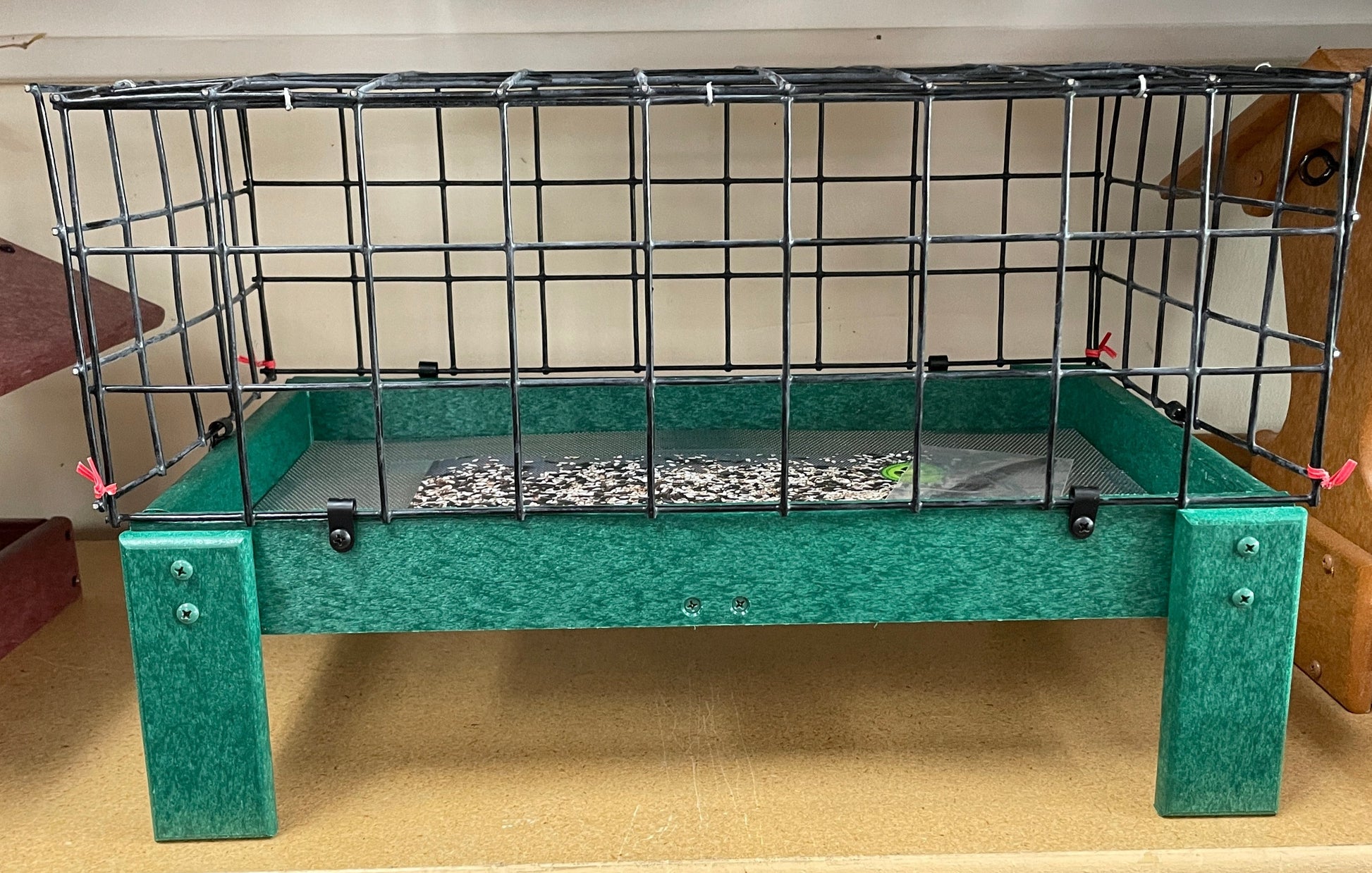 green recycle material tray with four legs and black cage, aka dove guard, attached