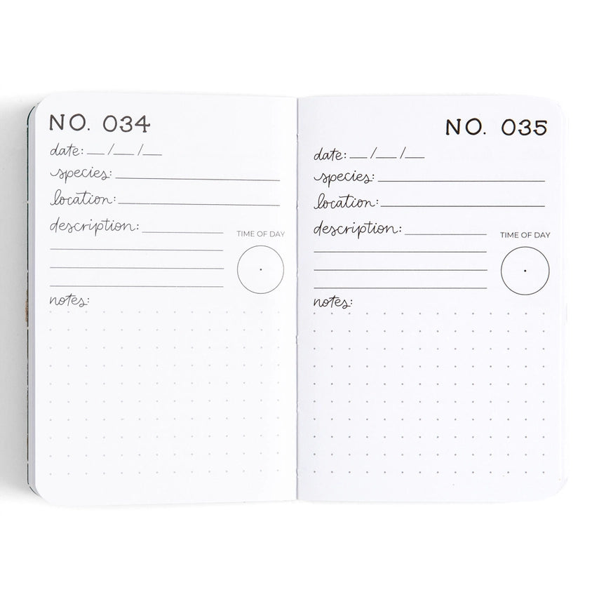 An open notebook showing two interior pages with dotted grids and handwritten fields for date, species, location, description, time of day, and notes. The pages are white with black printed text and lines, photographed on a clean white background.