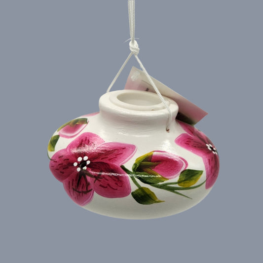 White ceramic feeder with red flowers