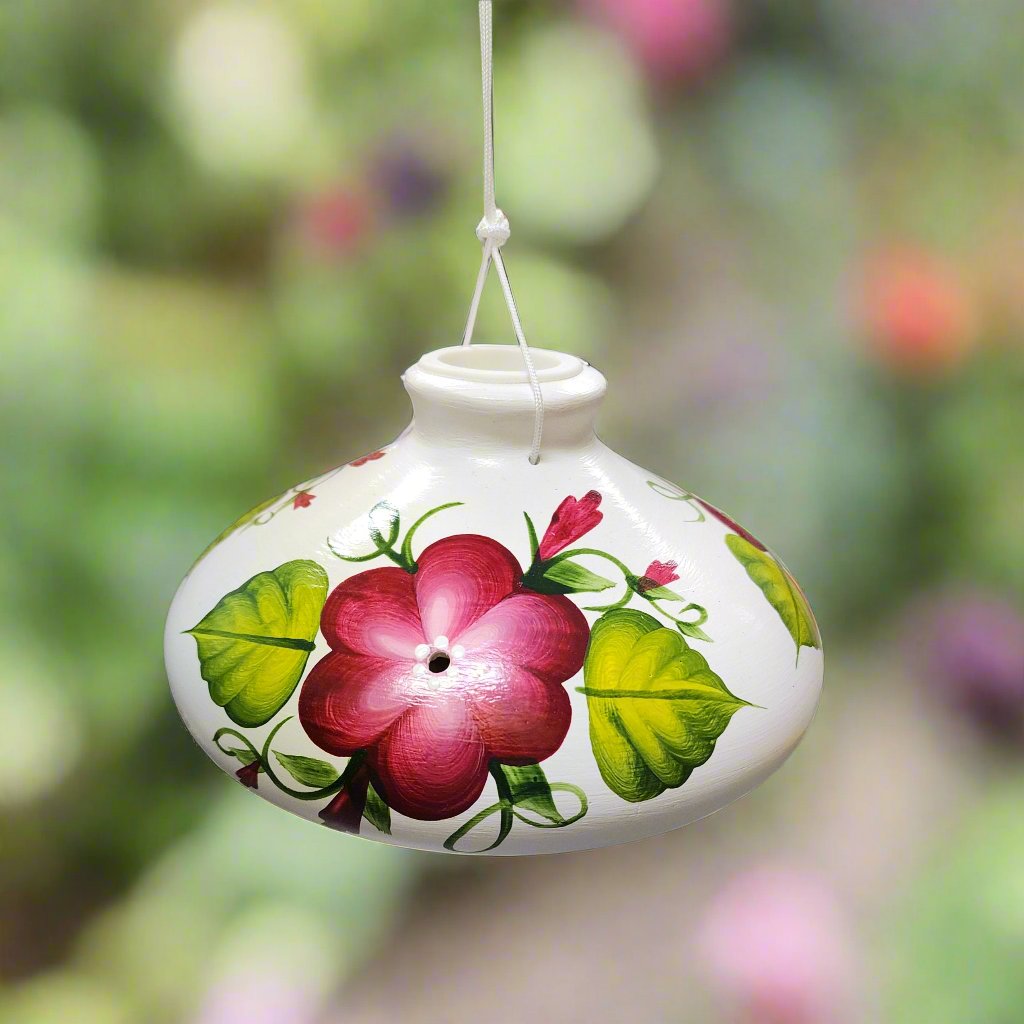 White ceramic feeder with garnet flowers and green leaves