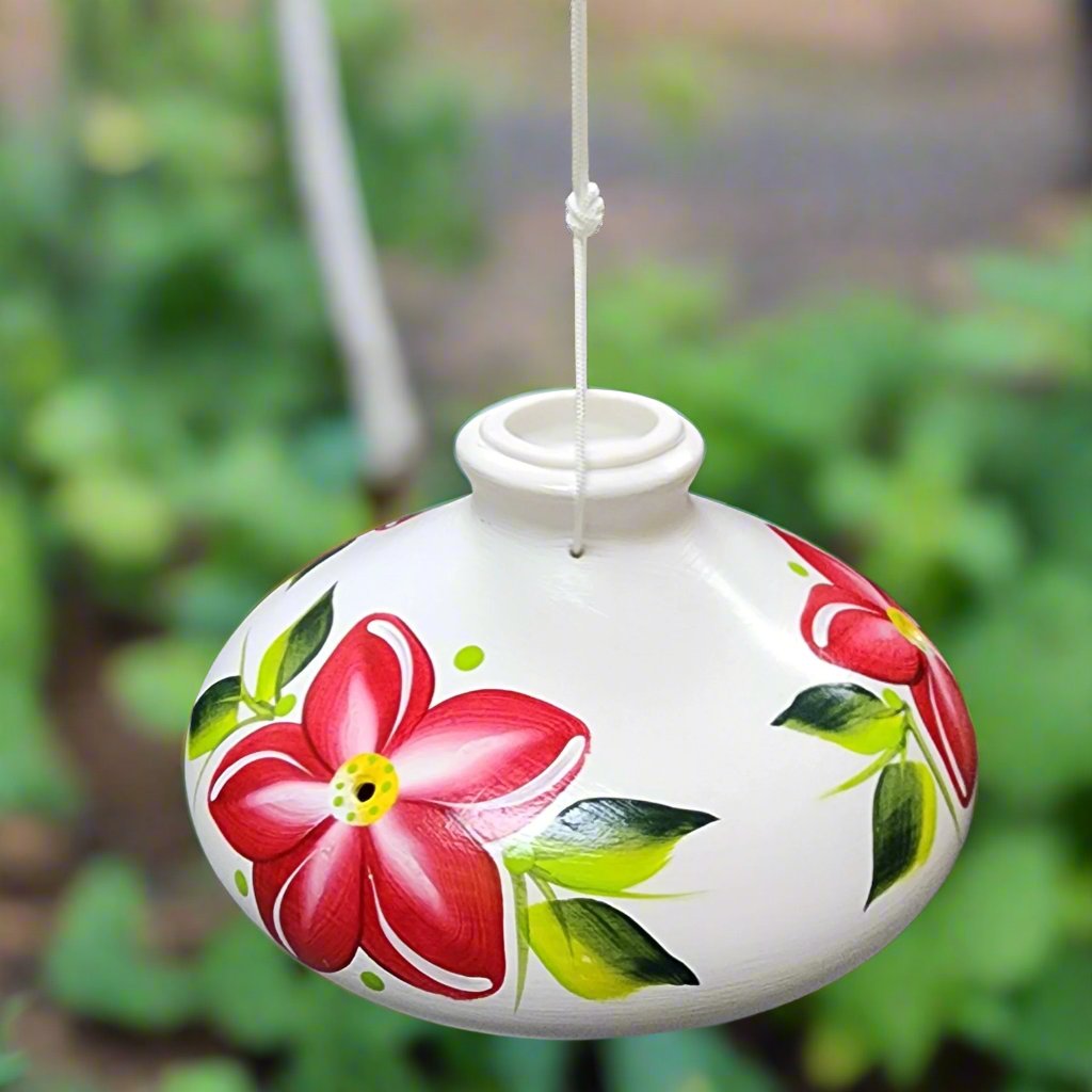 White ceramic feeder with garnet flowers and green leaves