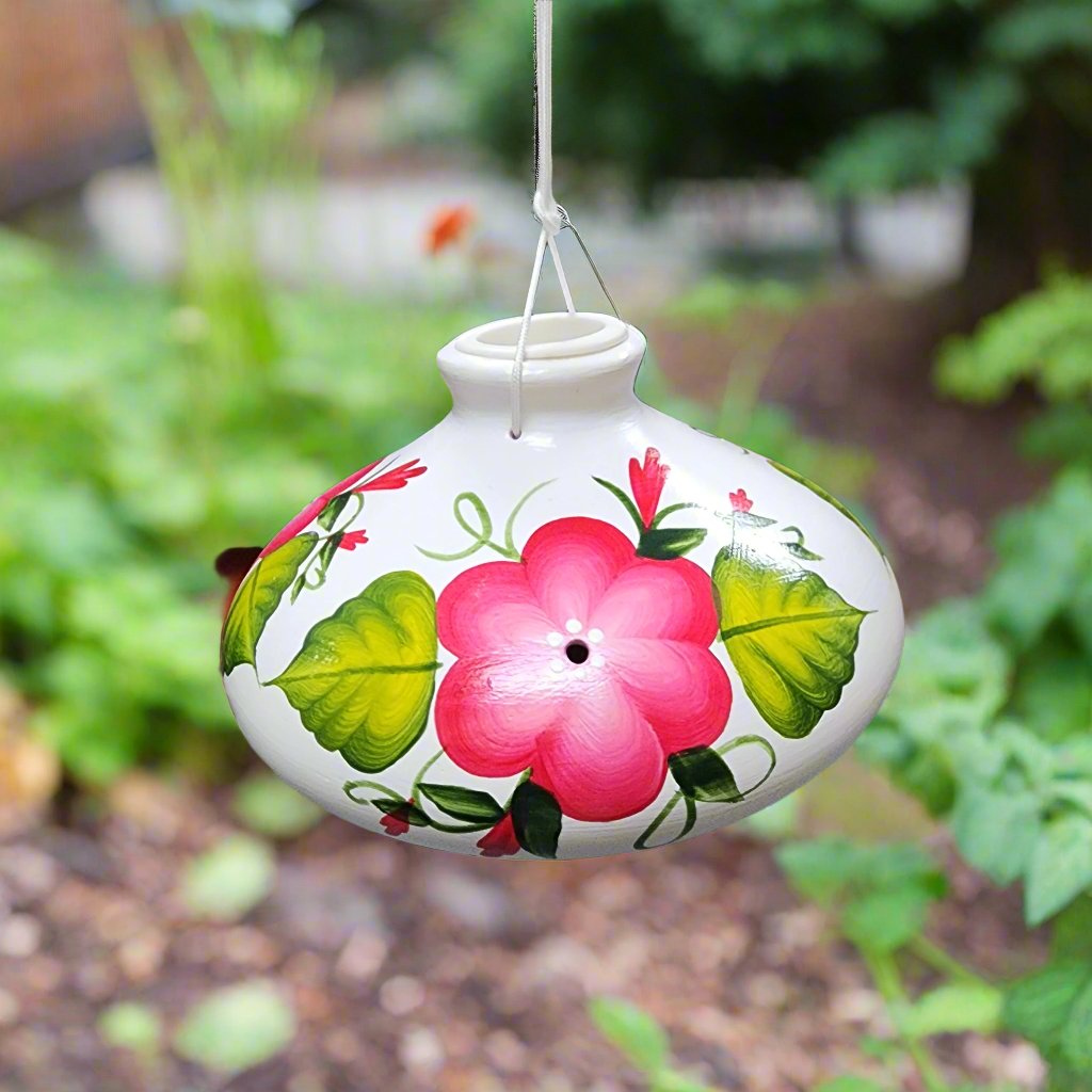 White ceramic feeder with red flowers and green leaves