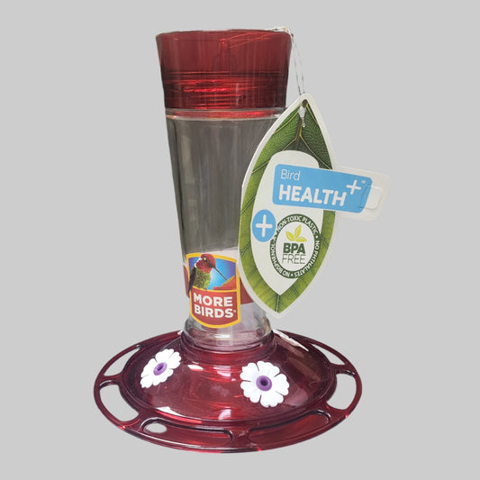 Red and clear feeder with white flowers