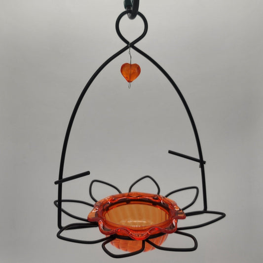 Black wire hanger with orange cup and heart dangle