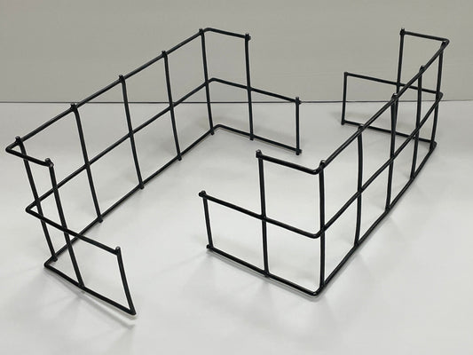 A black metal wire shelving organizer with a rectangular grid design, shown on a white tabletop with a white background.