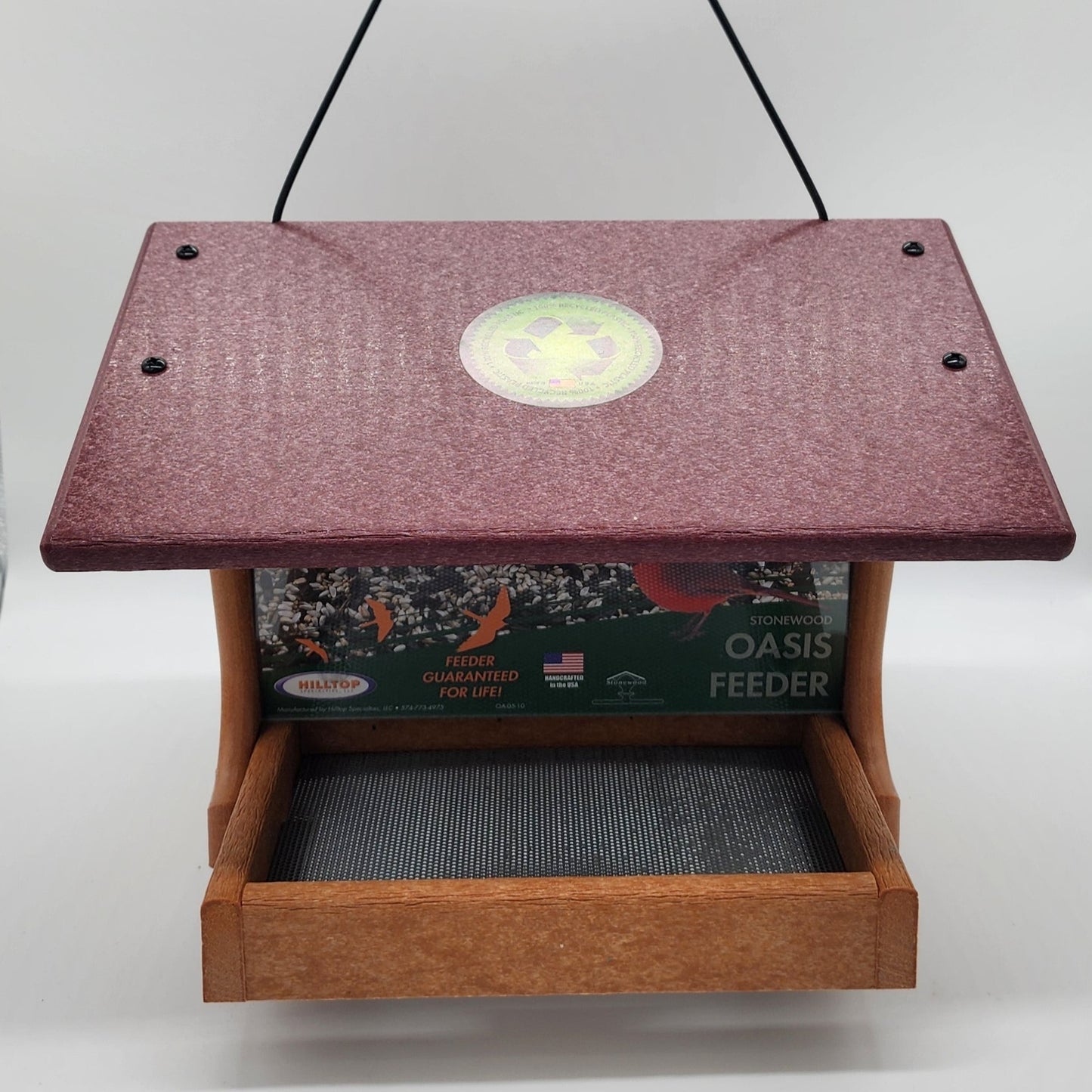 Tan bird feeder with cherry colored roof