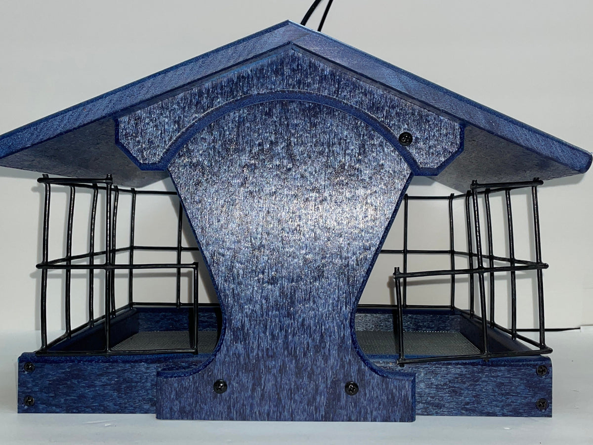 A blue bird feeder  and black metal wire cage sides, shown on a white surface with a white backdrop.
