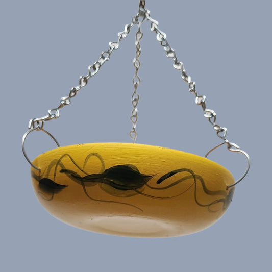  orange bowl with green leaves and silver hanging chains