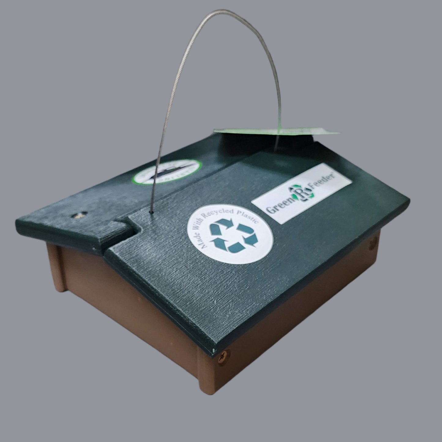 square tan feeder with green roof and wire hanger