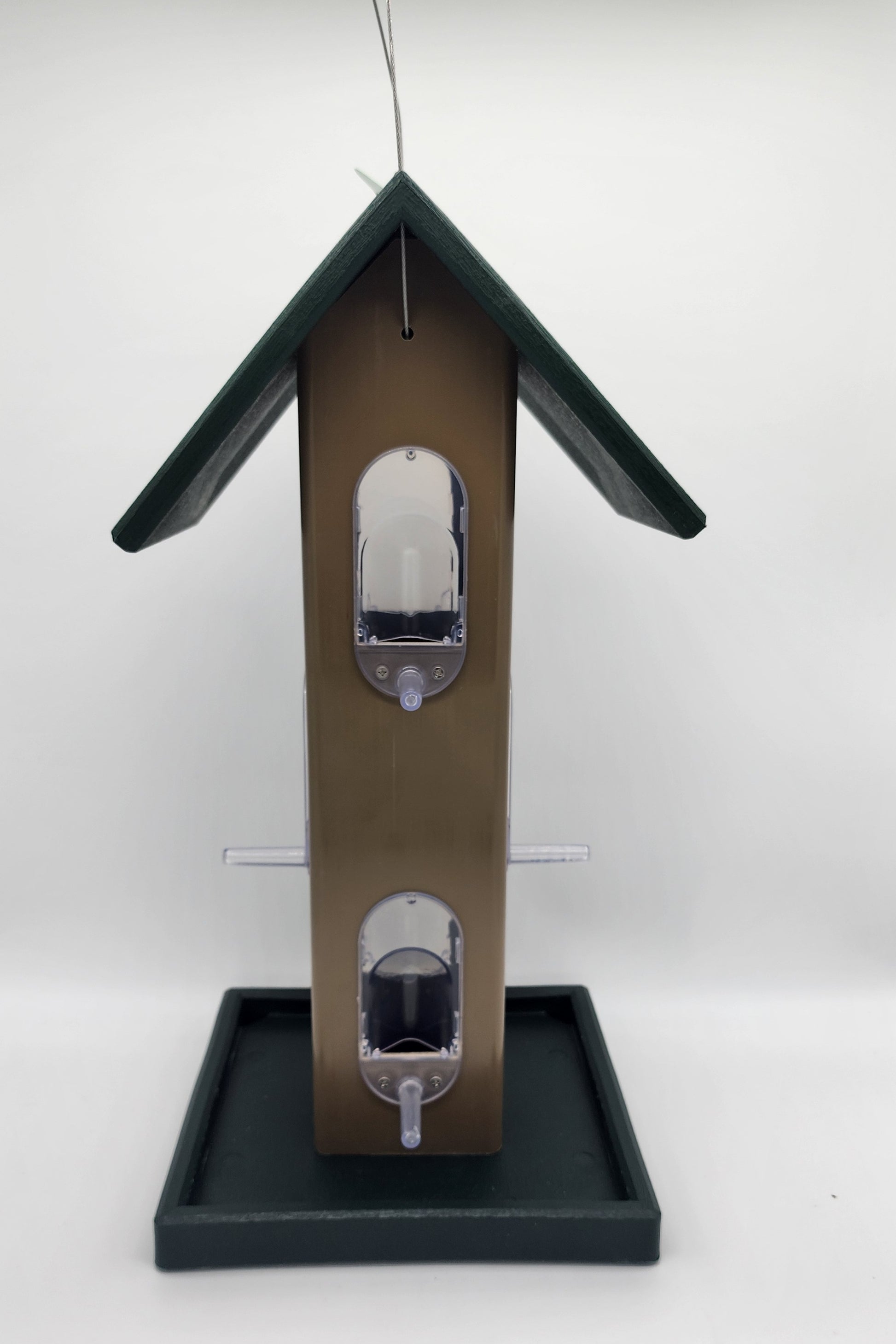 tan bird feeder with green roof and tray