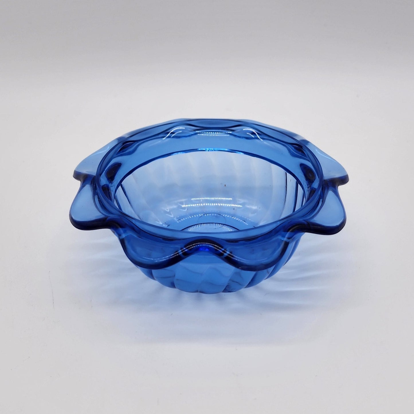 Blue plastic cup with scalloped edges