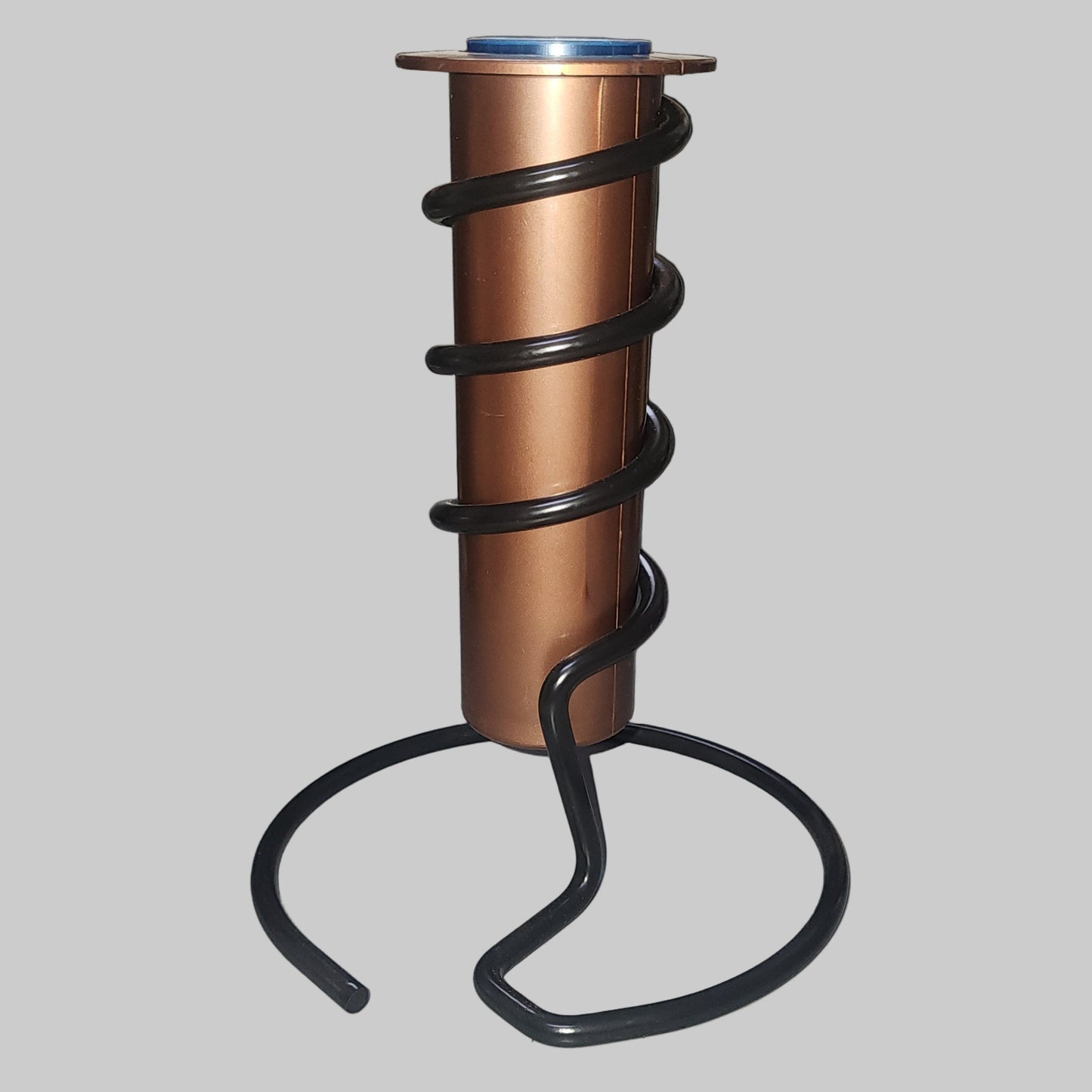 Copper rain gauge tube with black spiral holder and base
