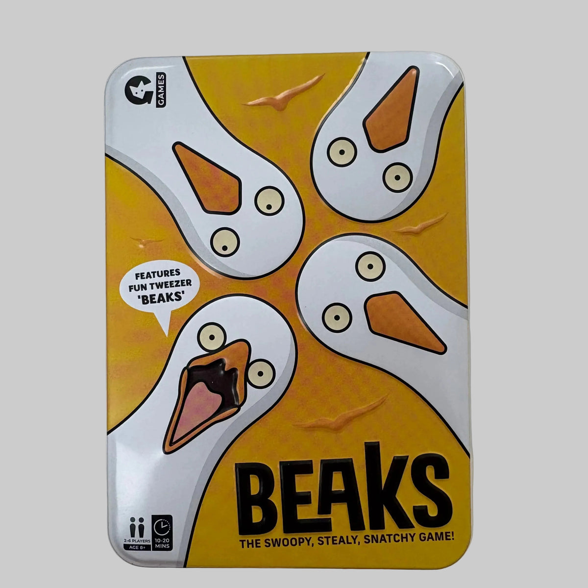 The game box for 'Beaks: The Swoopy, Stealy, Snatchy Game!' by G Games, featuring a yellow and white cartoon design of four beaks with black text.