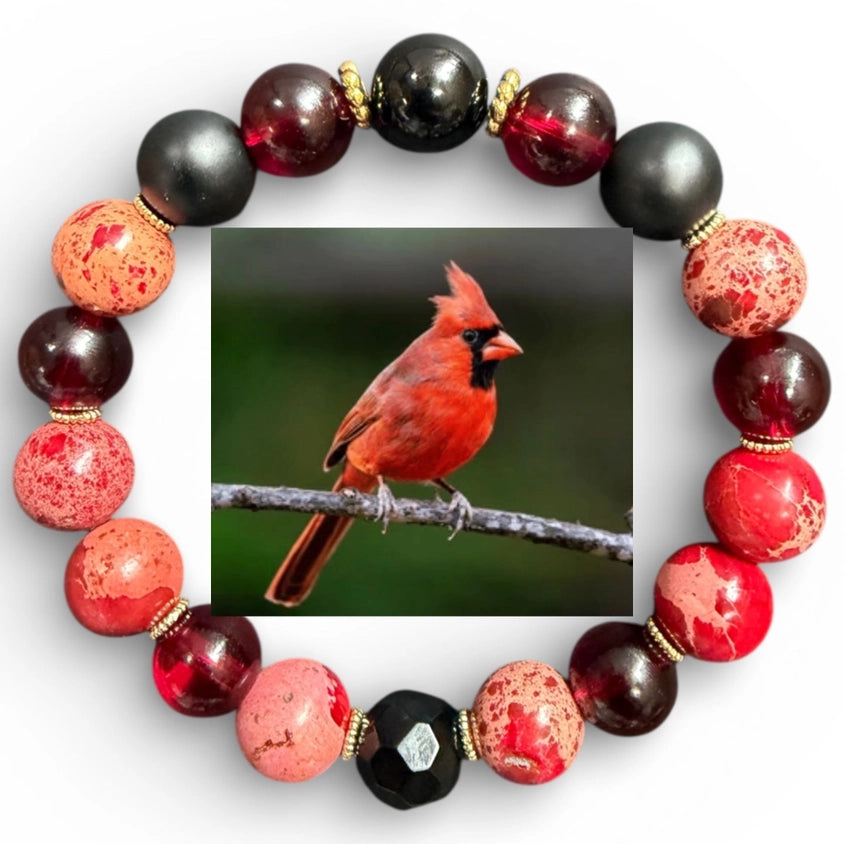 Bracelet with red, black, and pink beads featuring a picture of a cardinal bird.