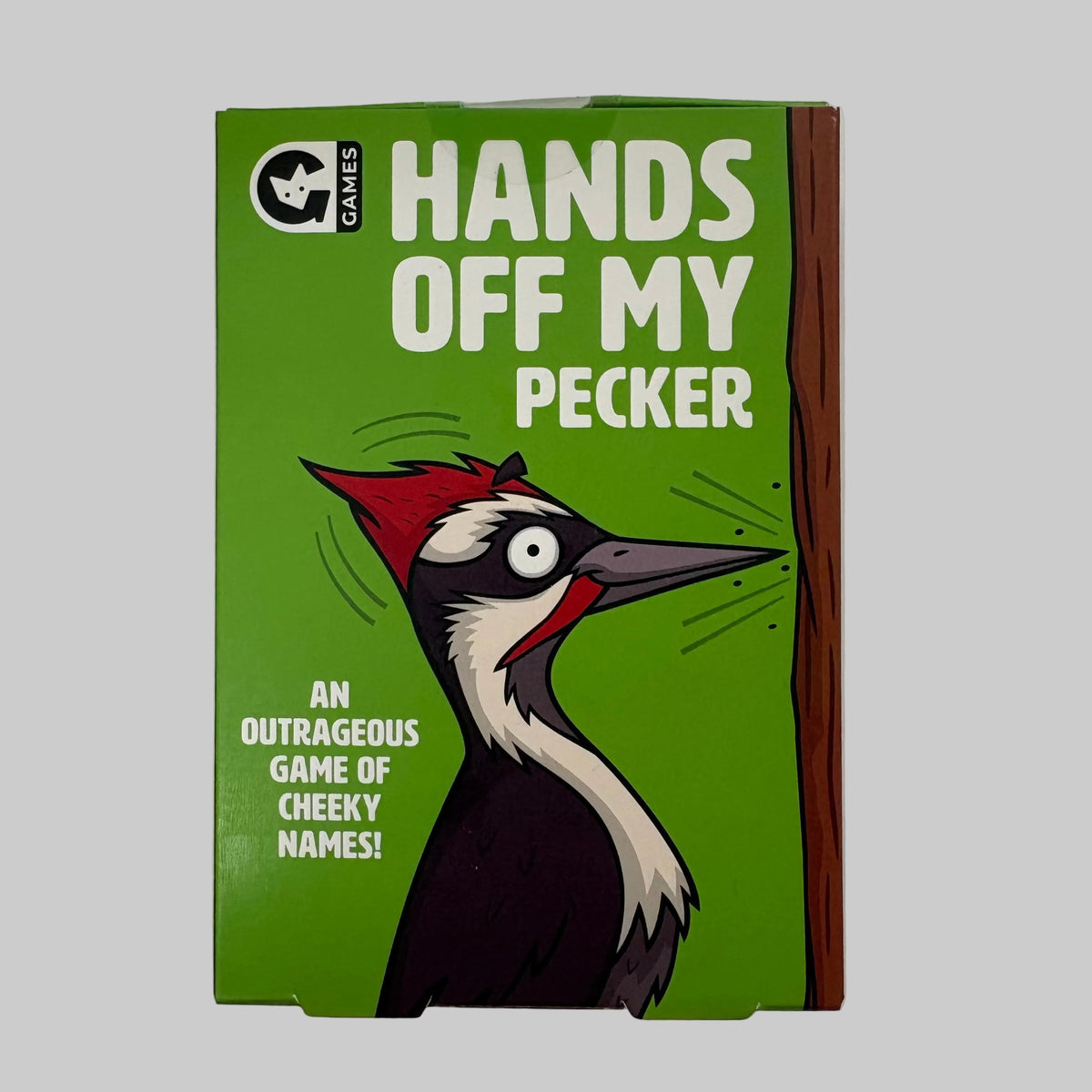The front of the game box for 'Hands Off My Pecker' by Q Games, featuring a bright green background with a cartoon woodpecker and bold white text.