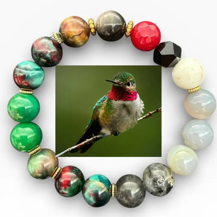 Multicolored beaded bracelet with a inset of a hummingbird on a white background