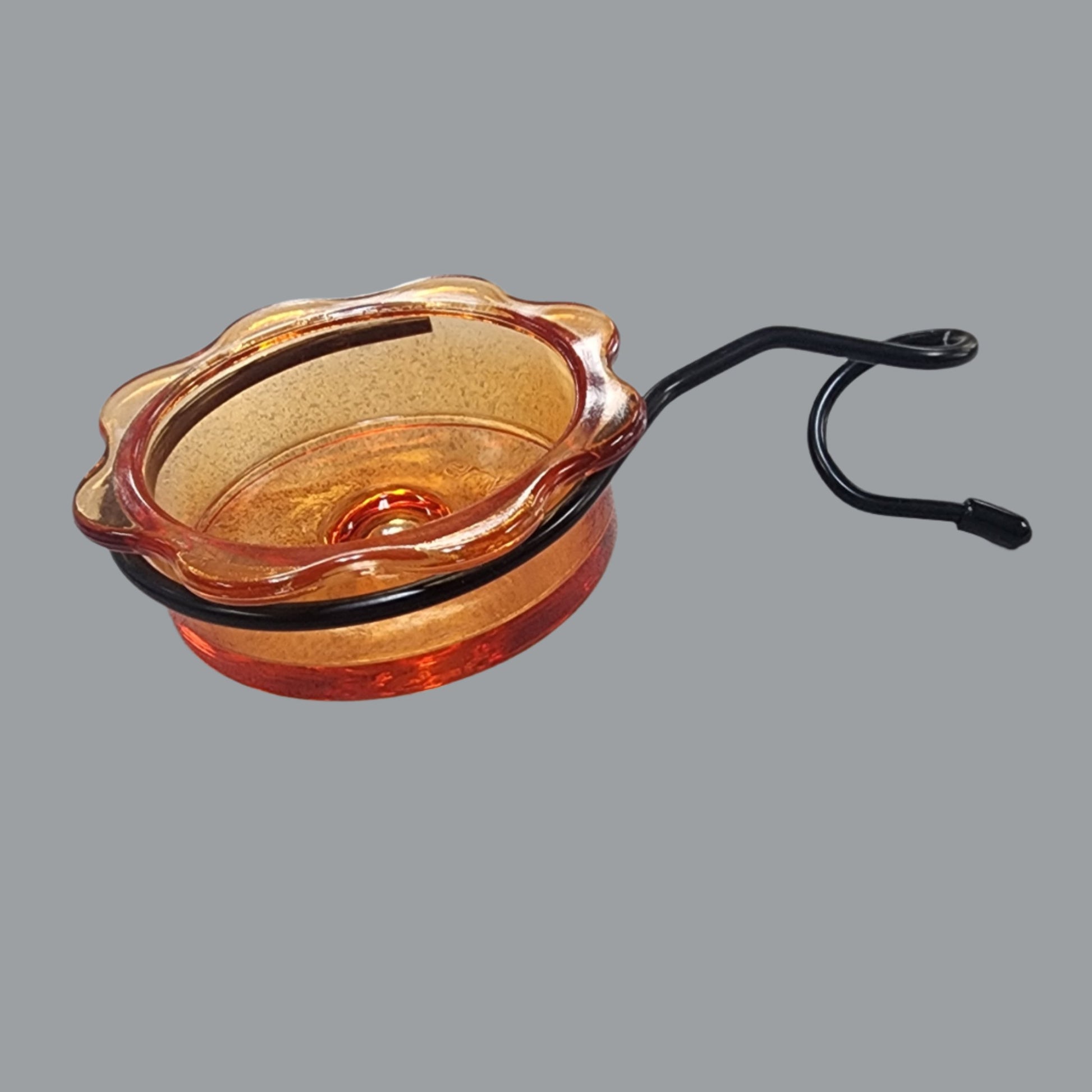 orange glass dish with black coil attachment