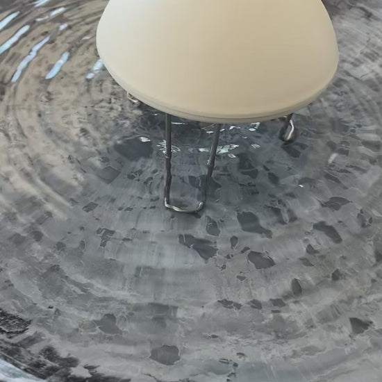 White water wiggler in gray bird bath agitating the water surface