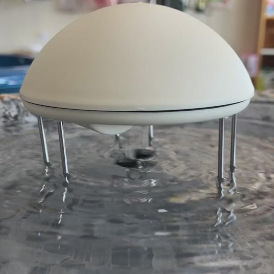 White water wiggler in gray bird bath agitating the water surface