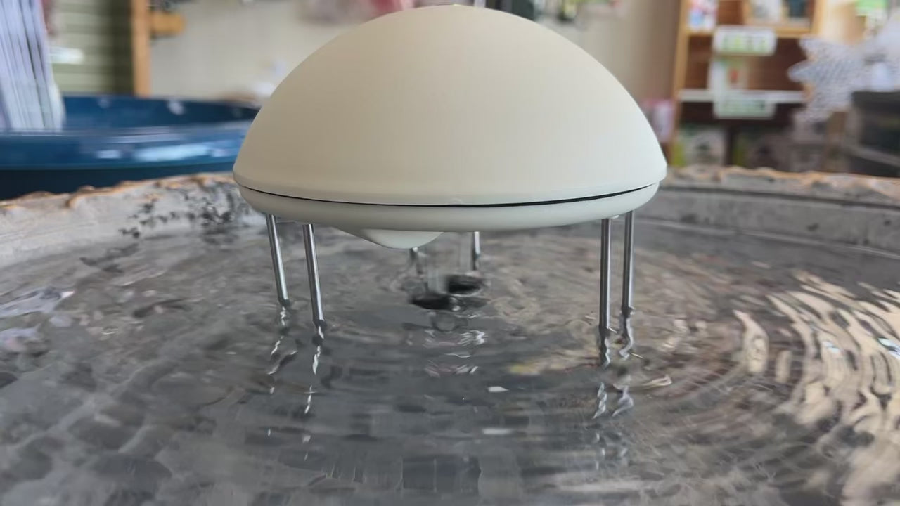 White water wiggler in gray bird bath agitating the water surface