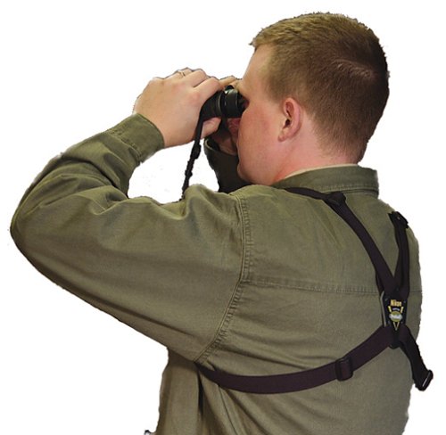 Gentleman using a pair of binoculars wearing a harness